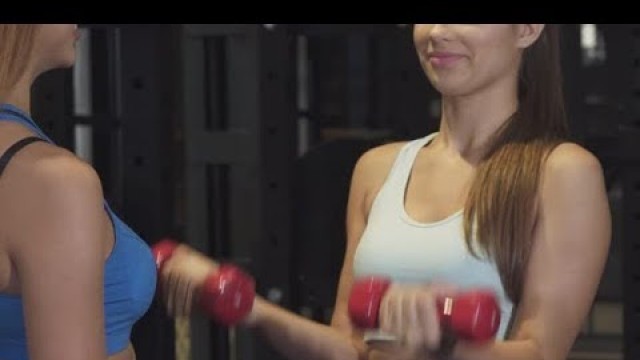 'Cropped Shot of a Professional Fitness Coach Helping Her Female Client at the Gym | Stock Footage'